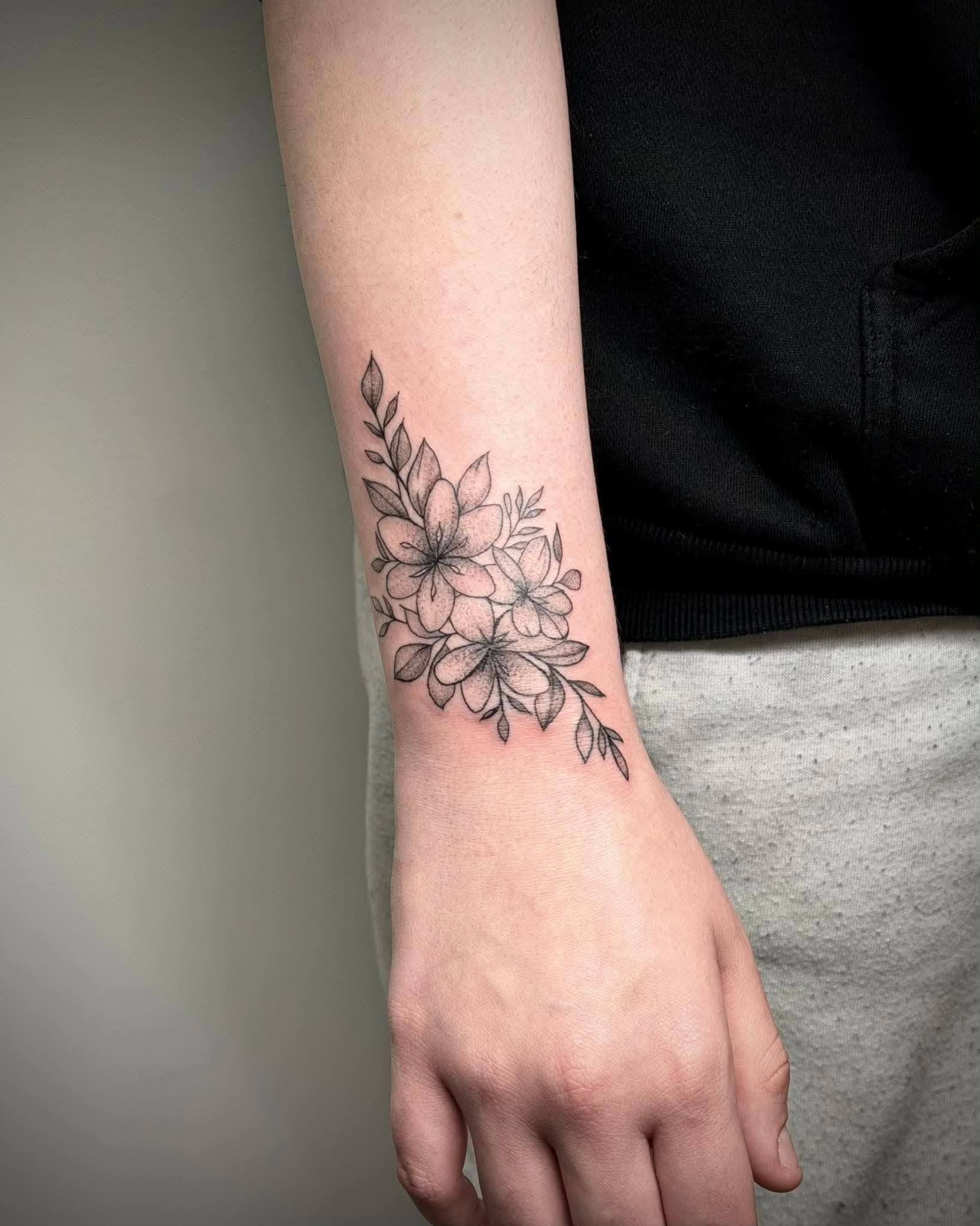 Blackwork floral tattoo on wrist